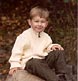 An energetic young boy climbs atop a rock at our Harpswell studio