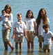 A group of cousins in the water at the end of an extended family sitting in Harpswell!