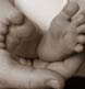 Baby's feet in Mom's hand.  Sepia toned.