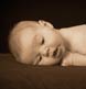 A two-week-old baby in a grainy sepia-toned look.