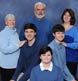 A family portrait nicely in key with blue clothing on a blue background!