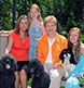 A family photographed in their own backyard.