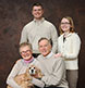 An in-studio family portrait with their beloved dog.