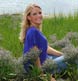 A stunning outdoor portrait with her purple blouse in key with the sea lavender.