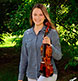 Showing her musical interest with her violin.