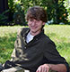 Leaning on a rock wall for a casual senior portrait.