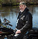 A gentleman with his Harley-Davidson motorcycle.